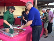 Jesse Wright  serves food at the Dobson Ranch  2019 Annual Meeting of the Members event