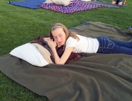 girl layingdown with pillow at Dobson Ranch 2020 Movie in the Park event