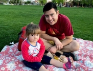 father and daughter on blanket at Dobson Ranch 2020 Movie in the Park event