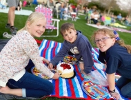 three kids on blanket with strawberry cake at Dobson Ranch 2020 Movie in the Park event