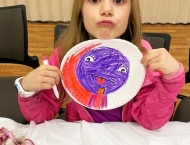girl making face holding her plate craft at Dobson Ranch  2020 Parents Night Out event