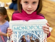 girl wins  Frozen Monopoly game prize at Dobson Ranch  2020 Parents Night Out event