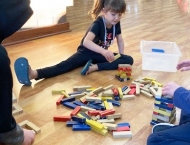 girl playing with wood blocks on floor at Dobson Ranch  2020 Parents Night Out event