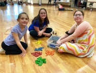 three girls playing games on floor at Dobson Ranch  2020 Parents Night Out event