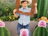 boy  in cowboy hat holding up frame at Dobson Ranch 2020 Preschool Graduation event