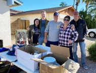 sresidents stand behind table of sale items at Dobson Ranch 2020 Spring Community Clean Up event