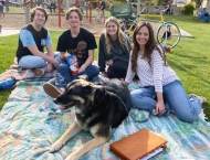 four teens relax on blanked with dog in park  at Dobson Ranch 2020 Sunday in the Park event