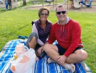 husband and wife sit on blanket in park  at Dobson Ranch 2020 Sunday in the Park event