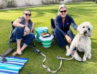 two women sitting in park with dog  at Dobson Ranch 2020 Sunday in the Park event