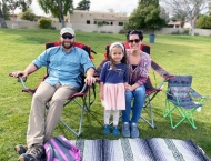 family of three relax in lawn chairs  at Dobson Ranch 2020 Sunday in the Park event