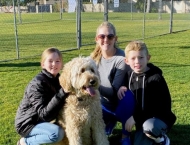Family of three with large dog at Dobson Ranch 2020 Winter Bark in the Park event
