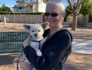 woman holding small white dog at Dobson Ranch 2020 Winter Bark in the Park event